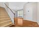 Inviting entryway with hardwood floors, staircase and a view into the dining area with natural light at 159 E Warfield Dr, Mooresville, NC 28115
