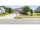 Charming home with a stone and siding exterior, two car garage, and a well manicured front yard at 159 E Warfield Dr, Mooresville, NC 28115