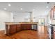 Open-concept kitchen with dark wood cabinetry, stainless appliances, granite counters and bar seating at 159 E Warfield Dr, Mooresville, NC 28115