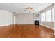 Comfortable living room with hardwood floors, fireplace, and abundant natural light from the large windows at 159 E Warfield Dr, Mooresville, NC 28115