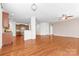 Expansive living space with hardwood floors, an open layout, and views into the modern kitchen at 159 E Warfield Dr, Mooresville, NC 28115