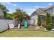Backyard featuring wooden playset, slide, swing and mulch pit at 159 E Warfield Dr, Mooresville, NC 28115
