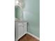 Powder room with modern vanity, decorative mirror, and wood floors at 159 E Warfield Dr, Mooresville, NC 28115