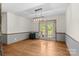 Light-filled dining area features hardwood floors and a modern light fixture with access to outdoor patio through glass doors at 160 Walking Horse Run, Stanley, NC 28164