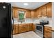 Bright kitchen equipped with a stainless-steel oven and plentiful wood cabinetry, blending functionality with a cozy aesthetic at 160 Walking Horse Run, Stanley, NC 28164