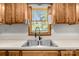 Kitchen sink nestled below an above-window offering a glimpse into the outside world, adding a refreshing view while you work at 160 Walking Horse Run, Stanley, NC 28164