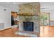 Living room showcasing stone fireplace, open floor plan, and access to kitchen at 160 Walking Horse Run, Stanley, NC 28164