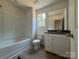 Bathroom featuring a bathtub and vanity with granite counters at 1727 E Cloaninger Ave, Statesville, NC 28625
