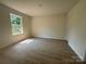 Bedroom with hardwood floors and a view from the window at 1727 E Cloaninger Ave, Statesville, NC 28625