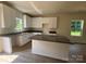 Bright kitchen with granite counters, an island and white cabinetry at 1727 E Cloaninger Ave, Statesville, NC 28625