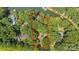 An aerial view shows the home site among beautiful wooded land on the water at 208 Island View Rd, Mount Holly, NC 28120