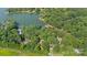 Aerial view of the property showcasing the lake, surrounding trees and neighborhood at 208 Island View Rd, Mount Holly, NC 28120