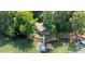 Lakefront home aerial showing lush landscape, private boat dock, screened porch, and outdoor entertaining area at 208 Island View Rd, Mount Holly, NC 28120