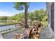 Back deck with rocking chairs and scenic views of the lake and surrounding trees at 208 Island View Rd, Mount Holly, NC 28120