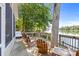 Relaxing back deck with rocking chairs and a hot tub, overlooking the serene lake at 208 Island View Rd, Mount Holly, NC 28120