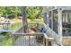 Relaxing wooden deck with chairs offering serene views of the lake and greenery at 208 Island View Rd, Mount Holly, NC 28120