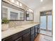 Bathroom featuring double sinks, a marble countertop, travertine tile backsplash, and a tiled shower at 208 Island View Rd, Mount Holly, NC 28120