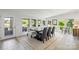 Bright dining area with tile floors, large windows, and views of the backyard and lake at 208 Island View Rd, Mount Holly, NC 28120