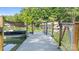 View of a dock featuring a covered boat slip and pontoon boat, offering direct access to the serene waters at 208 Island View Rd, Mount Holly, NC 28120