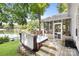 Outdoor hot tub and screened porch with scenic views of the lake and the surrounding trees at 208 Island View Rd, Mount Holly, NC 28120