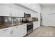 Modern kitchen featuring white cabinets, stainless steel appliances, and granite countertops at 208 Island View Rd, Mount Holly, NC 28120