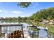 Tranquil lake view from the backyard deck with a pontoon boat docking at 208 Island View Rd, Mount Holly, NC 28120