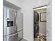 Efficient laundry room showcasing a stacked washer and dryer, adjacent to the stainless steel refrigerator at 208 Island View Rd, Mount Holly, NC 28120