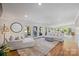 Bright living room with wood floors, lots of natural light and comfortable seating arrangement at 208 Island View Rd, Mount Holly, NC 28120