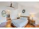 Bright main bedroom with wood floors, ceiling fan and ensuite bathroom access at 208 Island View Rd, Mount Holly, NC 28120