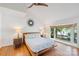 Bright main bedroom with wood floors, ceiling fan, and scenic views of the lake at 208 Island View Rd, Mount Holly, NC 28120