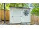 Small shed with decorative sun emblem, offering practical storage solutions within the property at 208 Island View Rd, Mount Holly, NC 28120