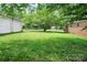 Spacious backyard featuring mature trees, lush grass, and a detached garage at 2215 Hodgin St, Gastonia, NC 28056