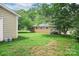 Brick home with a lush backyard including mature trees and a detached building at 2215 Hodgin St, Gastonia, NC 28056