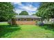 Quaint brick home with a well-manicured backyard and vibrant hydrangea bushes at 2215 Hodgin St, Gastonia, NC 28056