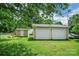 Backyard featuring a detached two-car garage, a shed, and mature trees at 2215 Hodgin St, Gastonia, NC 28056