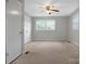 A carpeted room with a ceiling fan, and natural light from a window at 2215 Hodgin St, Gastonia, NC 28056