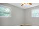 A carpeted room with natural light from two windows and a ceiling fan at 2215 Hodgin St, Gastonia, NC 28056