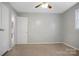 A bright bedroom featuring neutral carpet, fresh gray walls, and a ceiling fan at 2215 Hodgin St, Gastonia, NC 28056