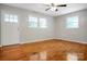 A bedroom with beautiful hardwood floors, natural light, and a ceiling fan at 2215 Hodgin St, Gastonia, NC 28056