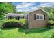 Charming brick home featuring black shutters and a lush green lawn at 2215 Hodgin St, Gastonia, NC 28056