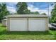Detached two-car garage featuring white doors in a well-maintained backyard at 2215 Hodgin St, Gastonia, NC 28056