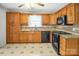 Kitchen with wooden cabinetry, tile backsplash, modern appliances at 2215 Hodgin St, Gastonia, NC 28056