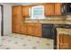 Functional kitchen with wooden cabinets and black appliances at 2215 Hodgin St, Gastonia, NC 28056
