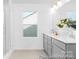 Bright bathroom with gray vanity, double sinks, a shower and modern fixtures at 233 Wheatfield Dr # 102P, Statesville, NC 28677