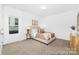 Inviting bedroom with plush bedding, warm lighting, and a view of the outdoors through a large window at 233 Wheatfield Dr # 102P, Statesville, NC 28677