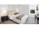 Bright bedroom with a plush bed, stylish side tables, and a large window offering abundant natural light at 233 Wheatfield Dr # 102P, Statesville, NC 28677