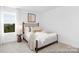 Comfortable bedroom showcasing a well-appointed bed, side table with lamp, and bright window views at 233 Wheatfield Dr # 102P, Statesville, NC 28677