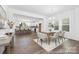 Elegant dining area with hardwood floors, modern lighting, and seamless access to the kitchen at 233 Wheatfield Dr # 102P, Statesville, NC 28677