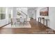 Open dining area with modern furniture, flowing into a living space and adjacent to the staircase at 233 Wheatfield Dr # 102P, Statesville, NC 28677