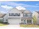 Charming two-story home with white siding, a two-car garage, and a welcoming front door at 233 Wheatfield Dr # 102P, Statesville, NC 28677